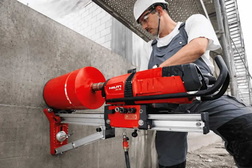 "فني شركة المهندس يستخدم ماكينة هيلتي (Hilti DD500) في قص وتخريم الخرسانة المسلحة بالسعودية بدقة عالية."